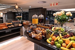 A buffet with various food items and a fruit display. - City Lodge Johannesburg Airport, Barbara Road (Edenvale)