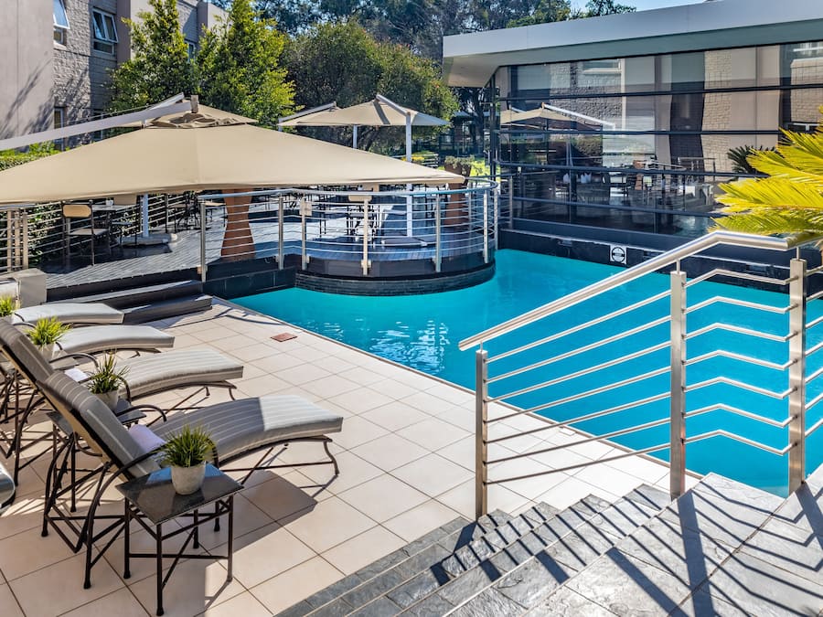 Outdoor pool, open 6 AM to 9 PM, pool umbrellas, pool loungers