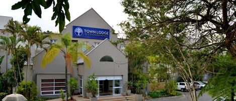 A modern building with a sign reading "Town Lodge by City Lodge Hotels".