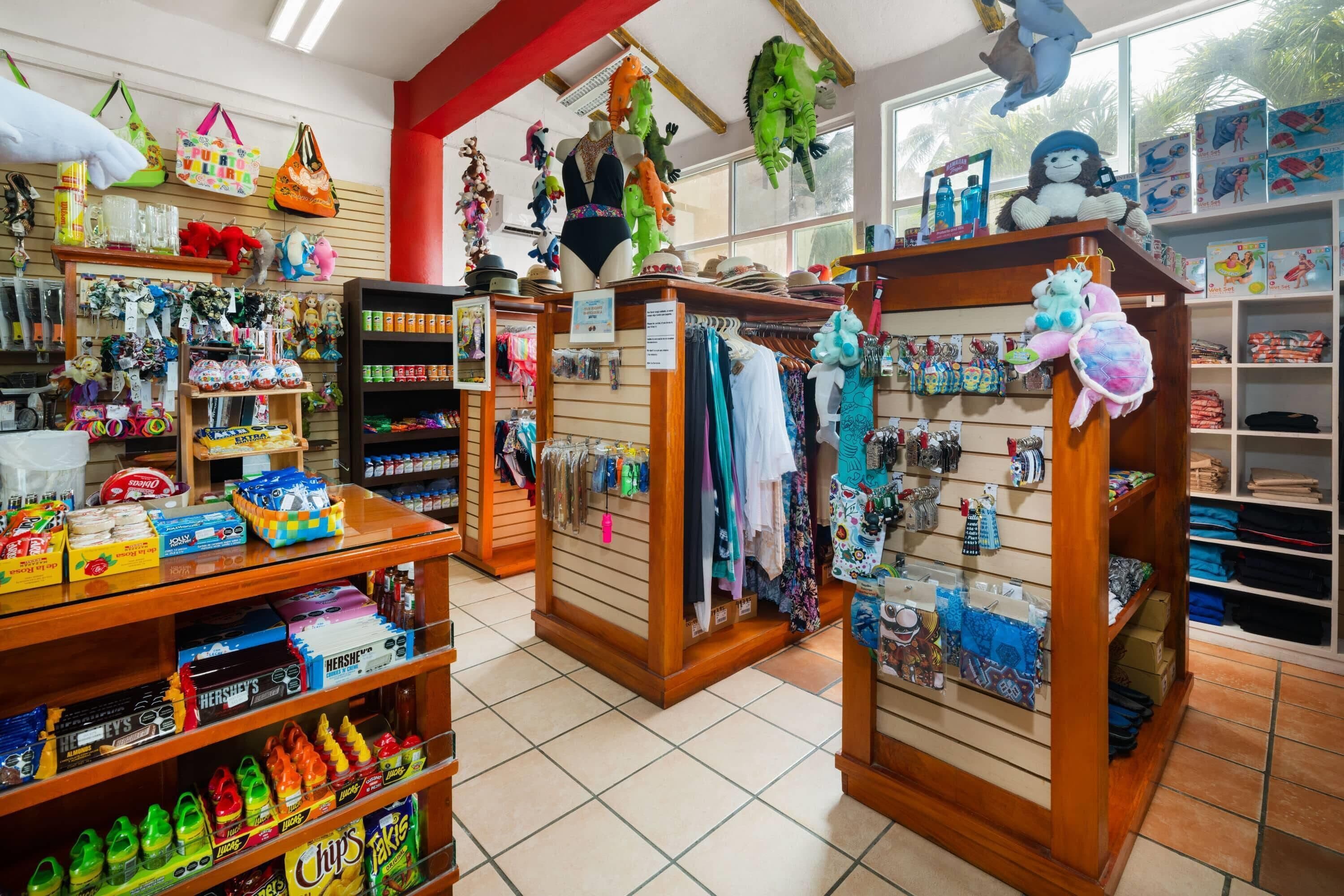 A store with shelves stocked with snacks, toys, and clothing.