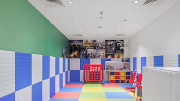 Children can play and explore in this vibrant play area with a colorful floor and fun play structure.