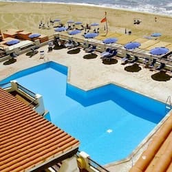 Relax by the pool and enjoy the beach views.