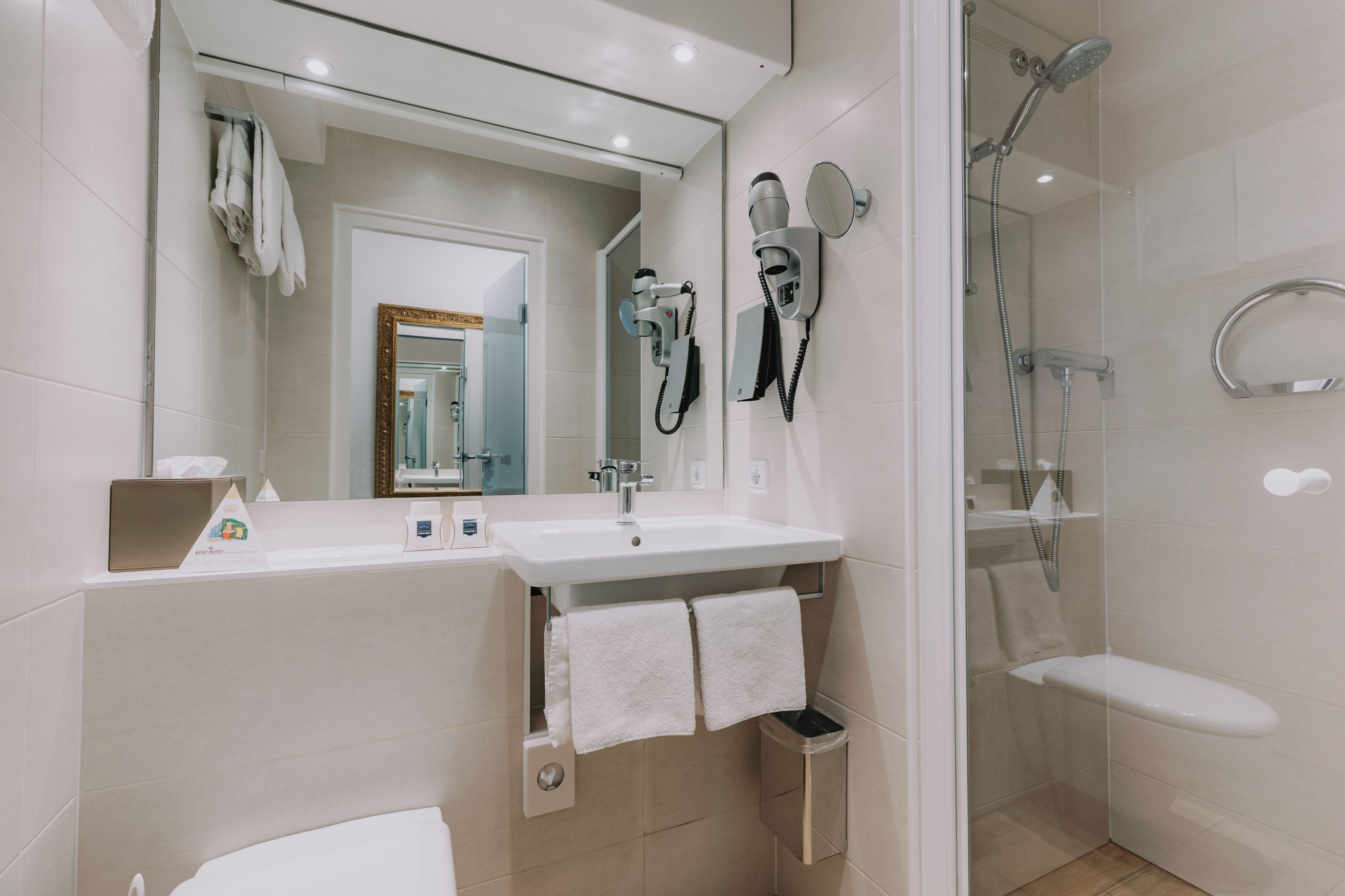 superior family room | bathroom | shower, hair dryer, towels, soap