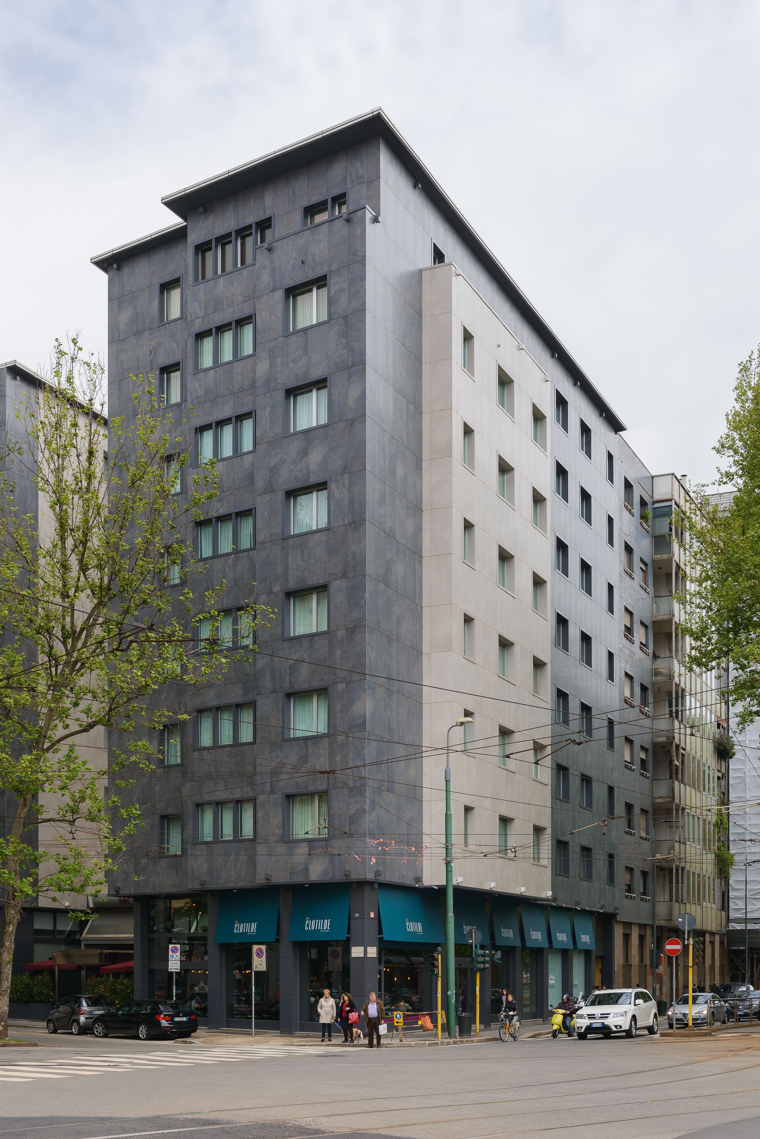 Um hotel de vários andares com design moderno, apresentando um telhado plano e fachada uniforme.