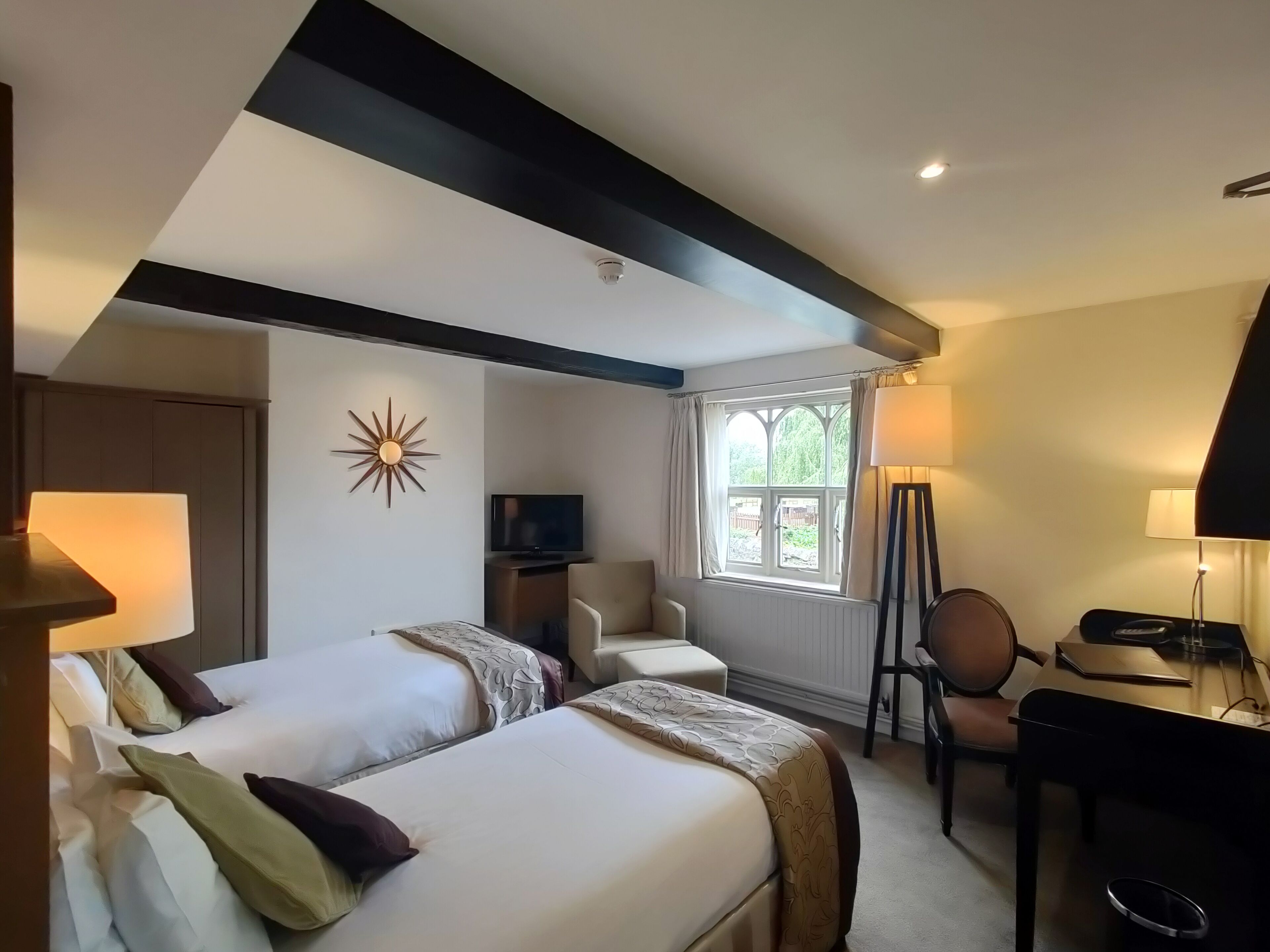 cottage twin room, river view | in-room safe, individually decorated, desk, laptop workspace