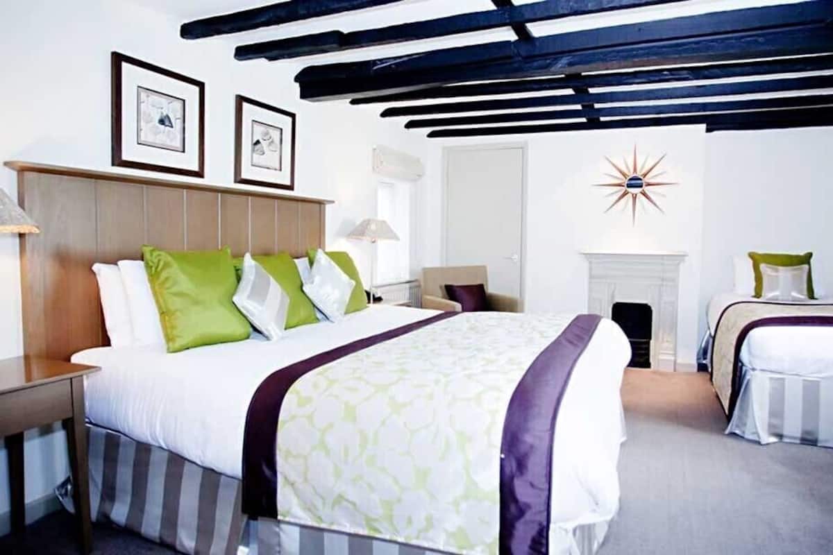 cottage double room, river view | in-room safe, individually decorated, desk, laptop workspace