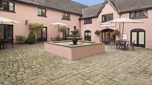 A pink building with a sign reading "RAMADA." - Cwrt Bleddyn Hotel & Spa (Usk)