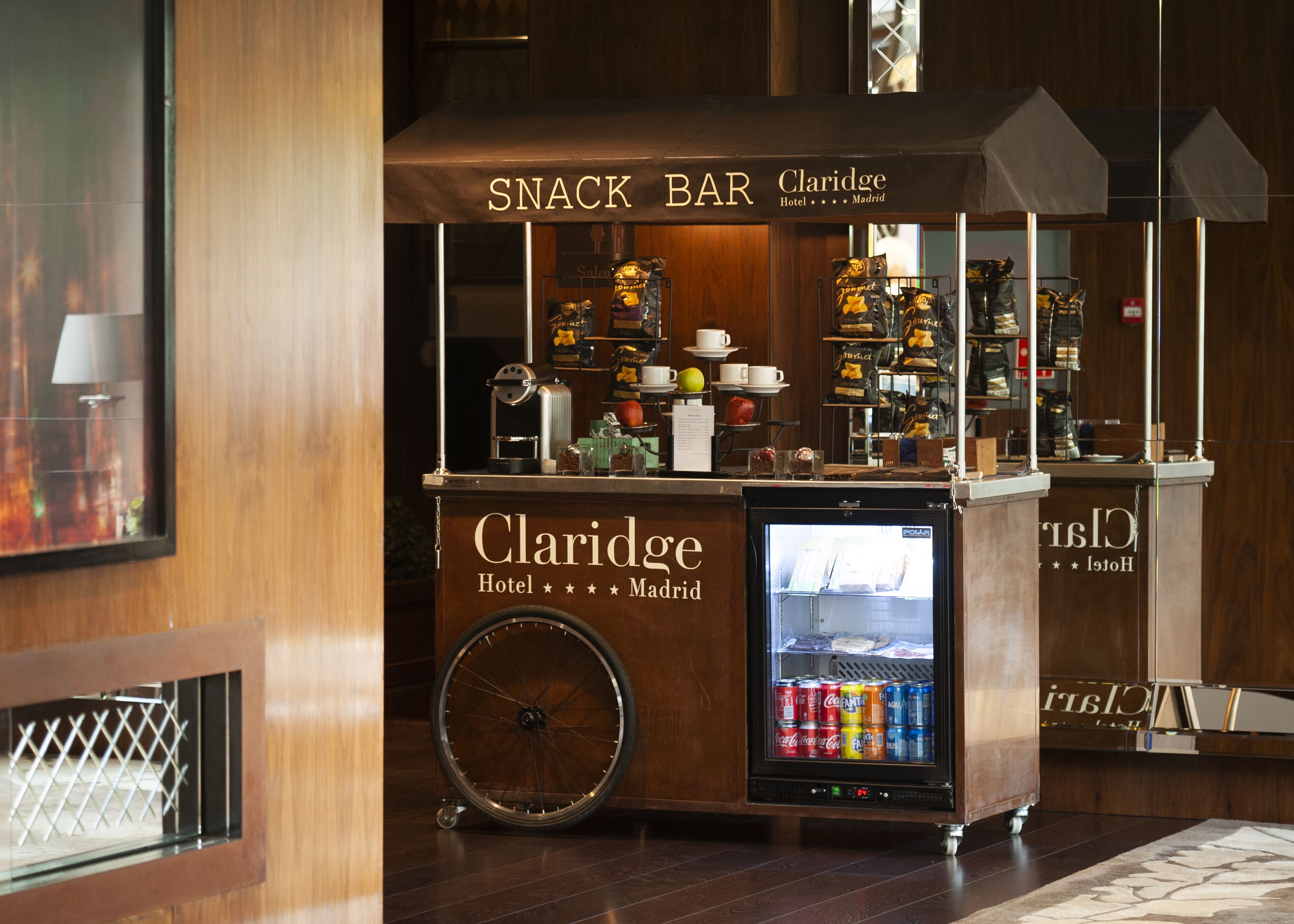 A snack bar with a refrigerated display and a coffee machine.