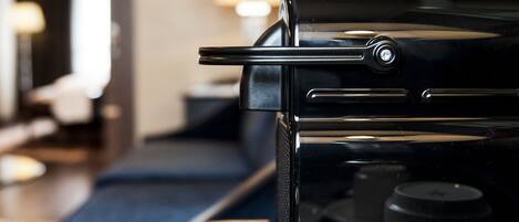 A coffee machine with a cup and saucer on a table.