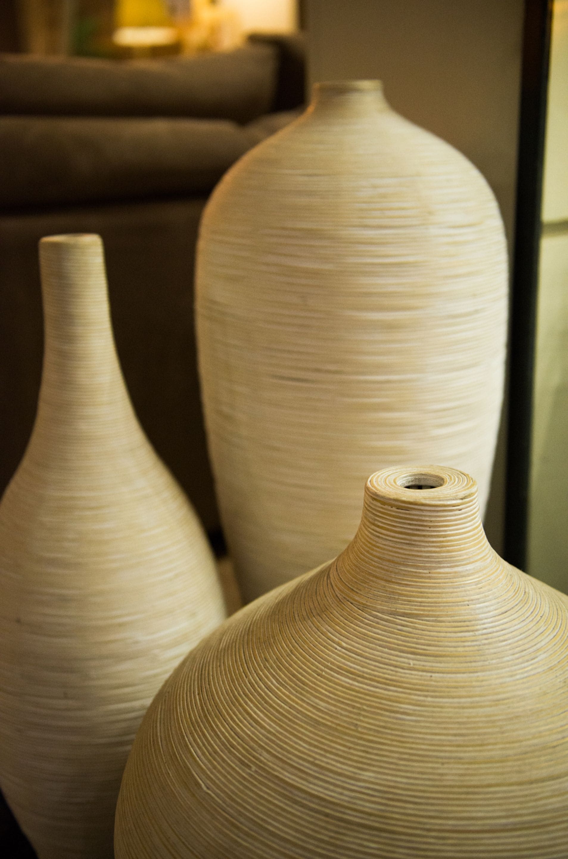 Three large, textured vases in a room.