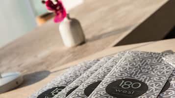 A close-up of a patterned table with a logo and text indicating '180 West' and 'jungle restaurant'.