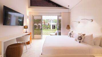 A modern hotel room with a bed, a desk, a television, and a view of the outdoors.