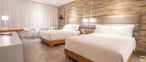 A modern hotel room with two beds, a desk, and a chair.