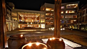 A modern hotel with a central open lobby, multiple floors, and a well-lit exterior. - Silks Place Taroko (Xiulin)