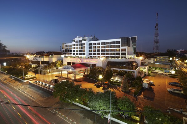 A modern hotel with a prominent sign, multiple floors, and a parking area. - Lao Plaza Hotel (Vientiane)