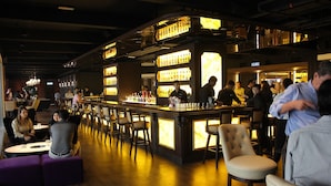 A bar area with a counter, stools, and a seating area with tables and chairs. - Hotel Armada Petaling Jaya (Petaling Jaya)