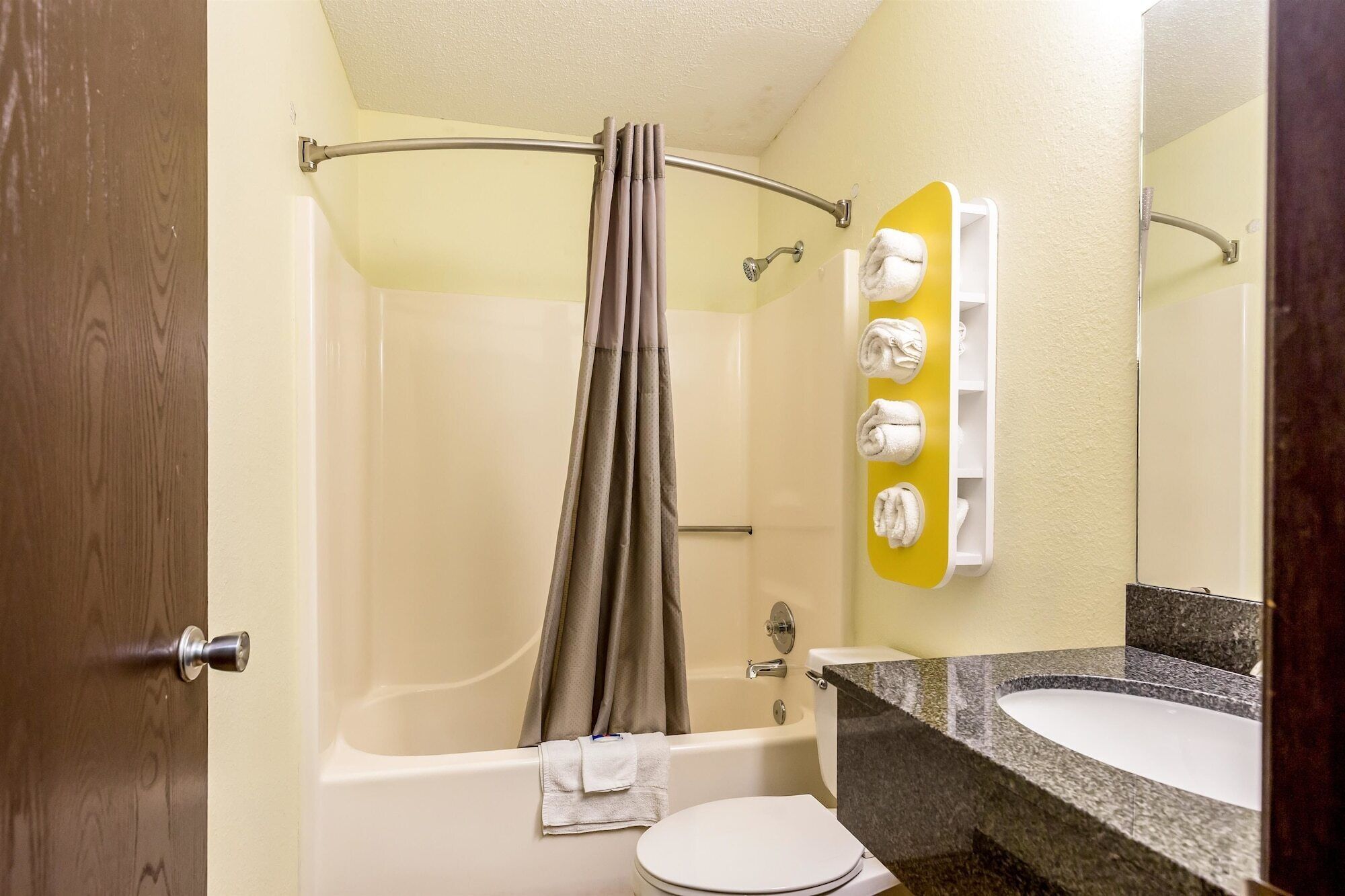 A bathroom with a bathtub, toilet, and sink.