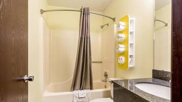 A bathroom with a bathtub, toilet, and sink.