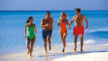 On the beach, white sand, sun-loungers, beach towels