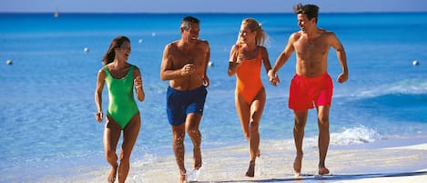 On the beach, white sand, sun loungers, beach towels