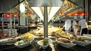 A buffet with various dishes and a central serving area.
