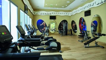 Una palestra con tapis roulant, ellittiche e attrezzature per sollevamento pesi.