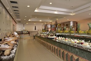 A buffet area with various food items and bakery goods.