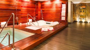 Relax in a serene spa room with a large hot tub and glass-enclosed jacuzzi area.