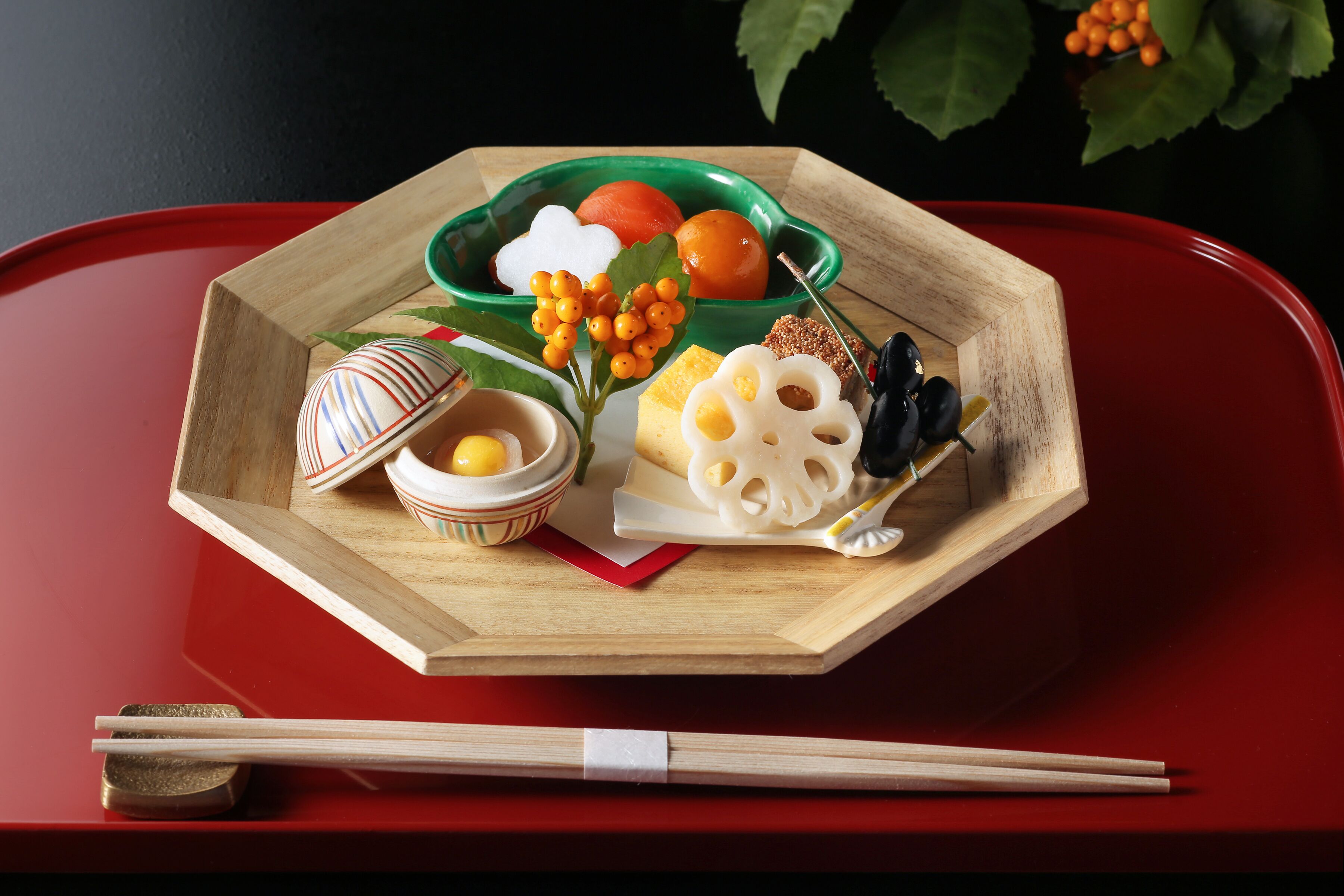 A wooden tray with a green bowl containing various fruits and a small bowl of rice.