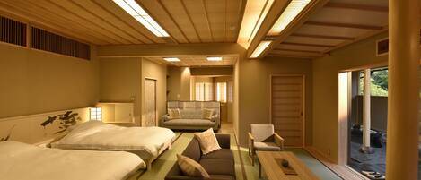 A traditional Japanese-style room with tatami flooring, a low wooden ceiling, and sliding doors leading to an outdoor area.