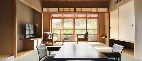 A traditional Japanese-style room with tatami flooring, a low table, and sliding doors.
