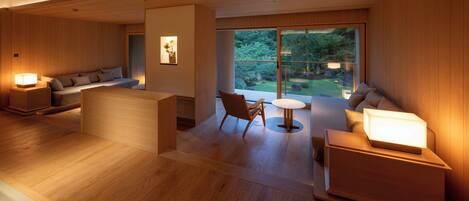 Un intérieur moderne avec un plancher en bois, un canapé, un fauteuil et une petite table.