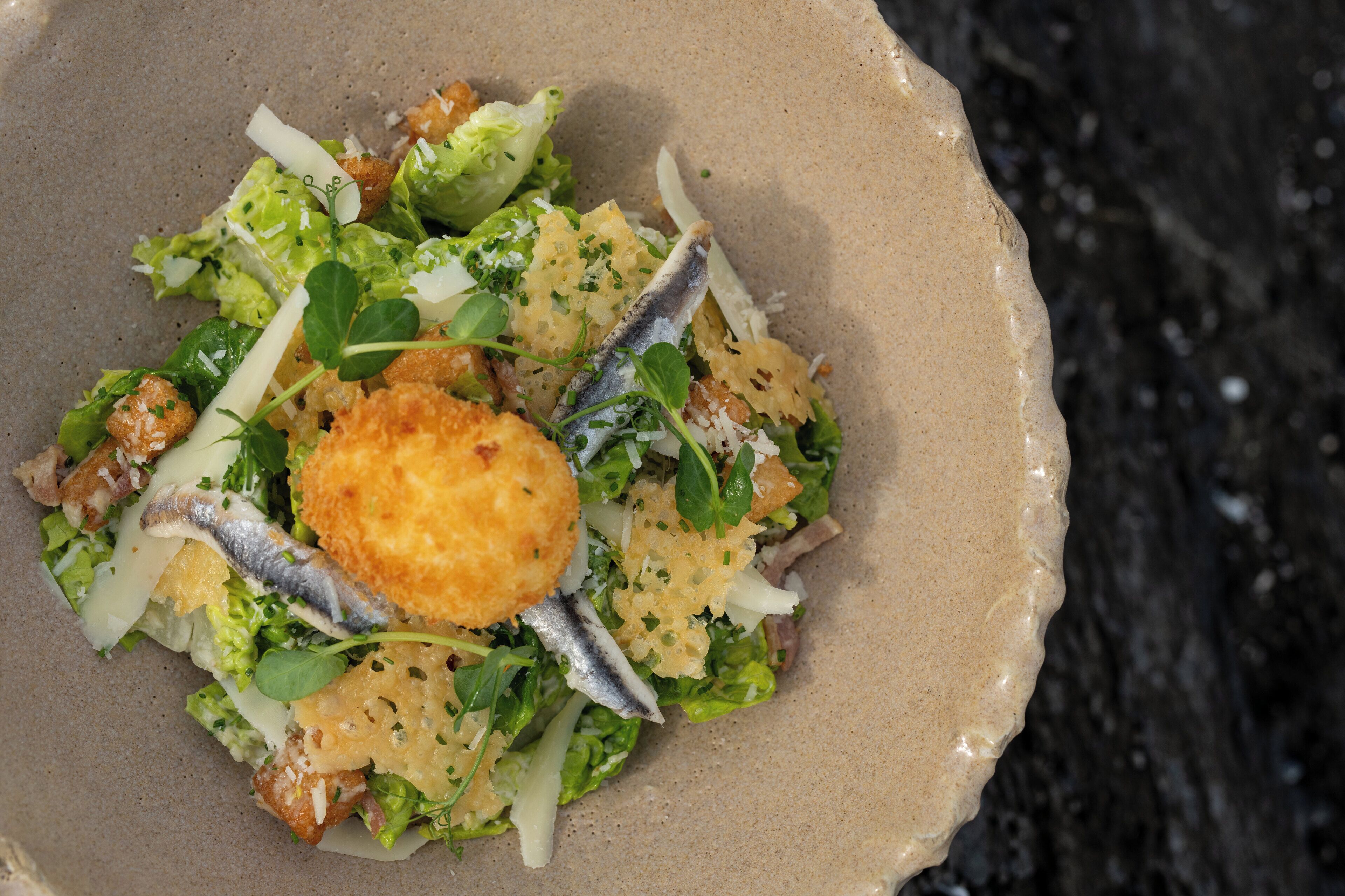 A bowl of salad with various ingredients.