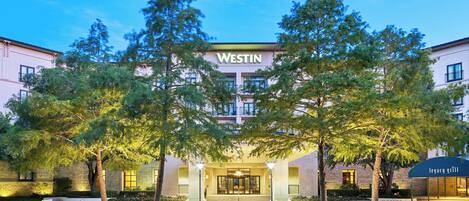 A Westin hotel entrance with a covered outdoor seating area named Legacy Grill.