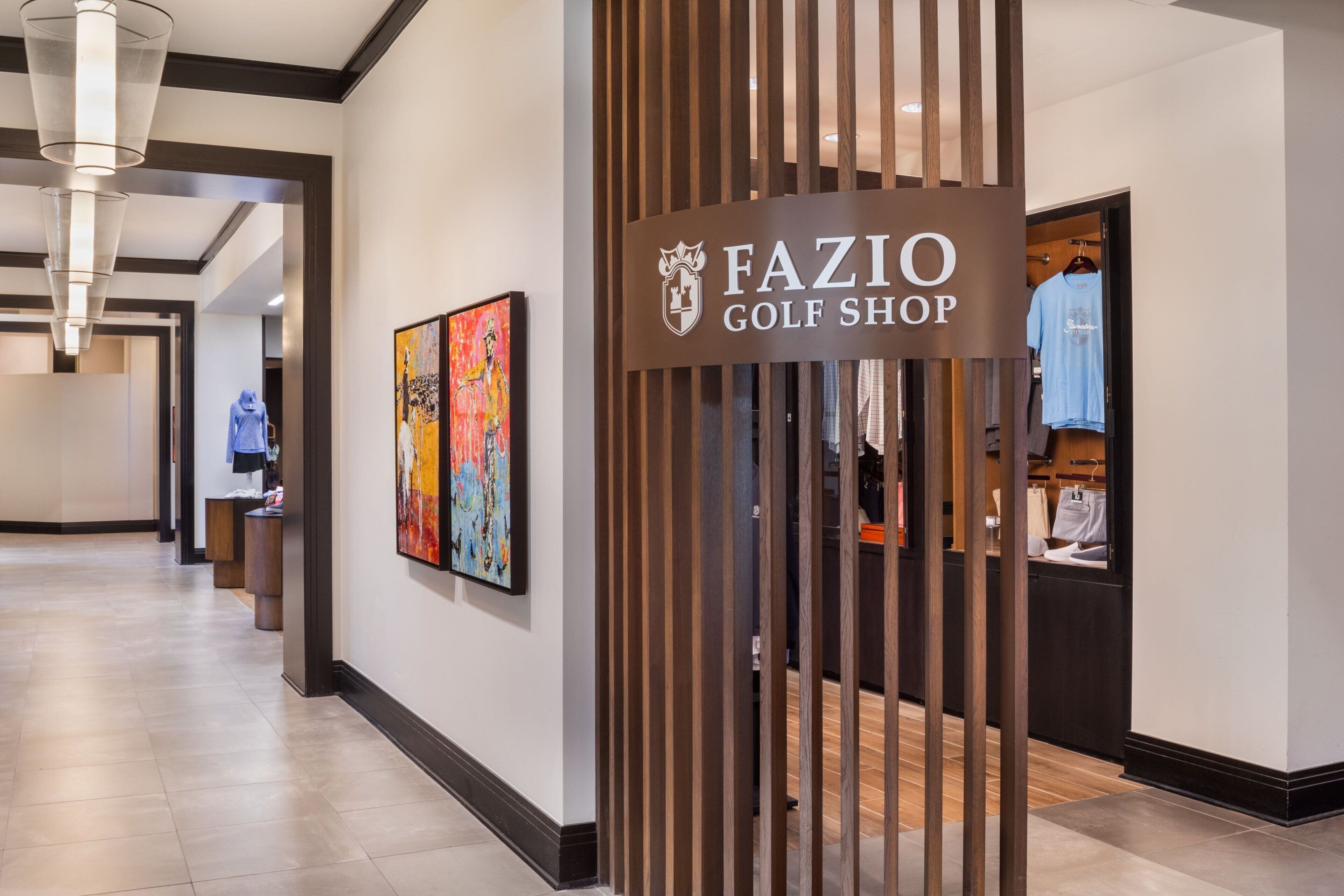 A hallway with a sign for 'FAZIO GOLF SHOP' and a clothing store.