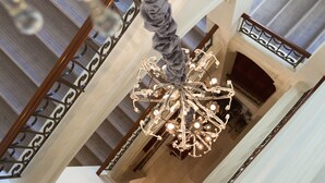 A grand chandelier in a spacious, elegantly designed interior with high ceilings and intricate railings. - Grand Palace Hotel – Small Luxury Hotels of the World (Riga)