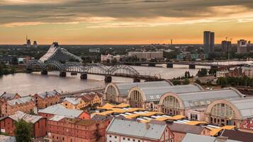 A cityscape with a prominent bridge, historic buildings, and a river.