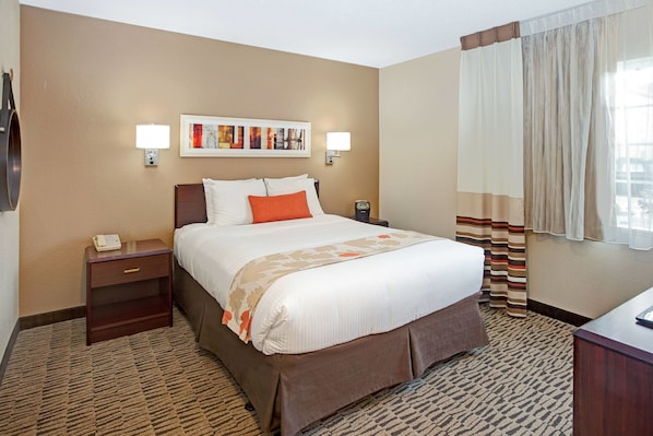 Premium bedding, pillow-top beds, desk, laptop workspace