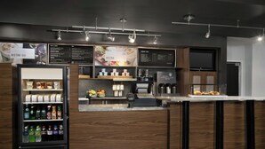 A modern bistro bar with a refrigerated beverage display, a coffee station, and a menu board. - Courtyard by Marriott Lakeland (Lakeland)