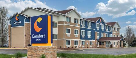 A Comfort Inn hotel with a modern design, featuring multiple floors and a prominent signage.