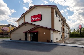 A Red Roof Inn with a red awning, a clear sky, and a parking lot. - Red Roof Inn Culpeper (Culpeper)