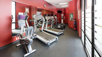 A gym with treadmills, a stationary bike, and a weight machine.