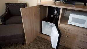 A compact room with a built-in refrigerator, a microwave, and a small cabinet. - The Great Falls Inn by Riversage (Great Falls)