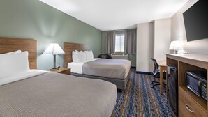 A hotel room with two beds, a desk with a computer, a microwave, and a TV. - Quality Inn Meadville (Meadville)