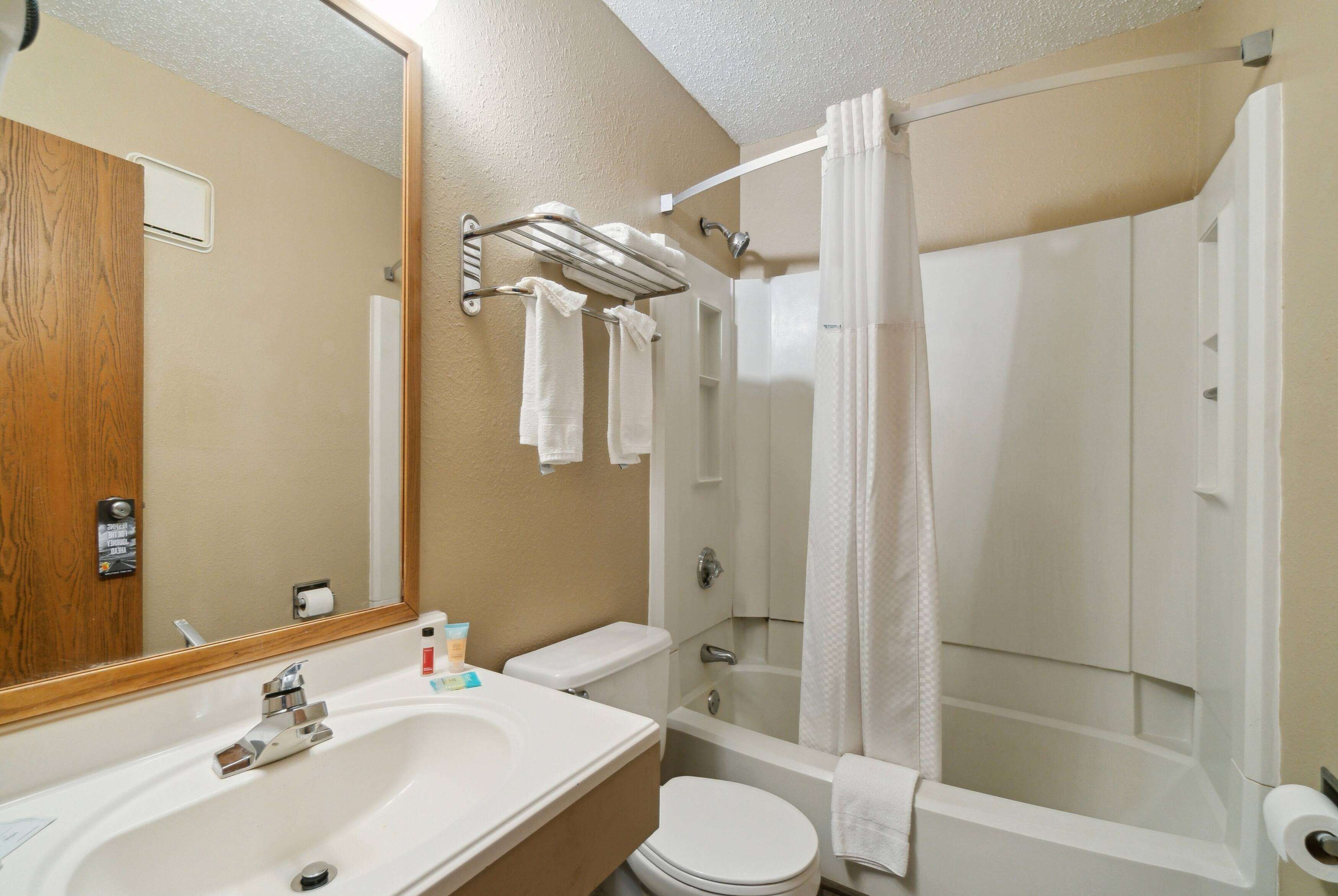 A bathroom with a sink, toilet, and bathtub.