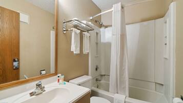 A bathroom with a sink, toilet, and bathtub.