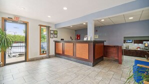 A reception area with a counter, a fire extinguisher, and a television.