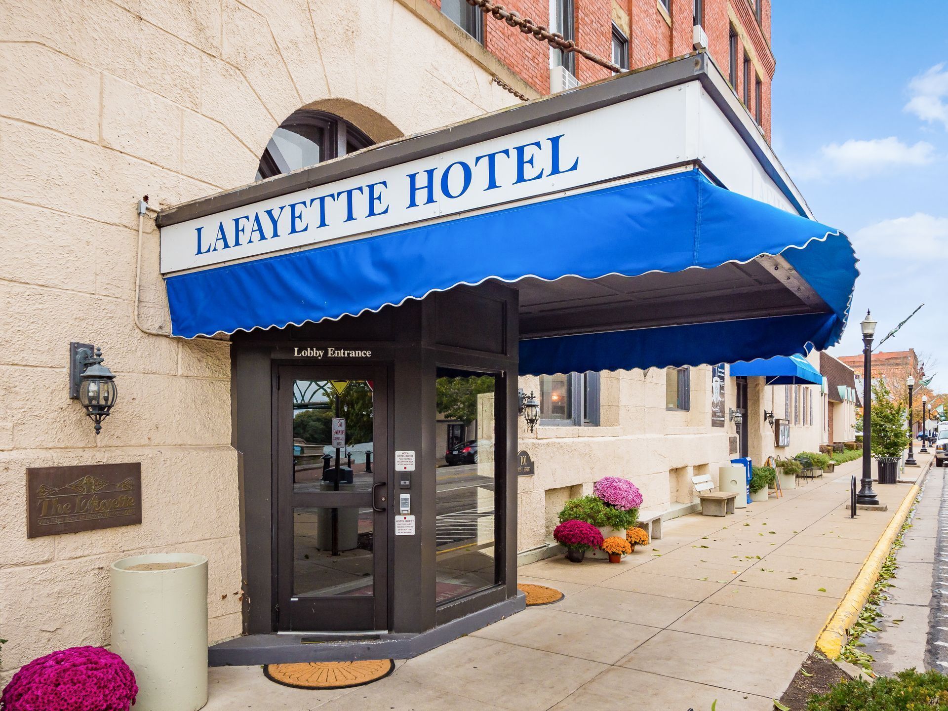 The Lafayette Hotel with a blue awning and a lobby entrance.