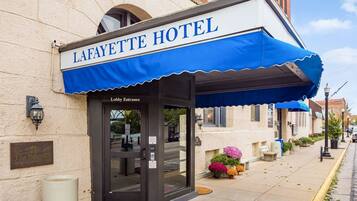 The Lafayette Hotel with a blue awning and a lobby entrance.