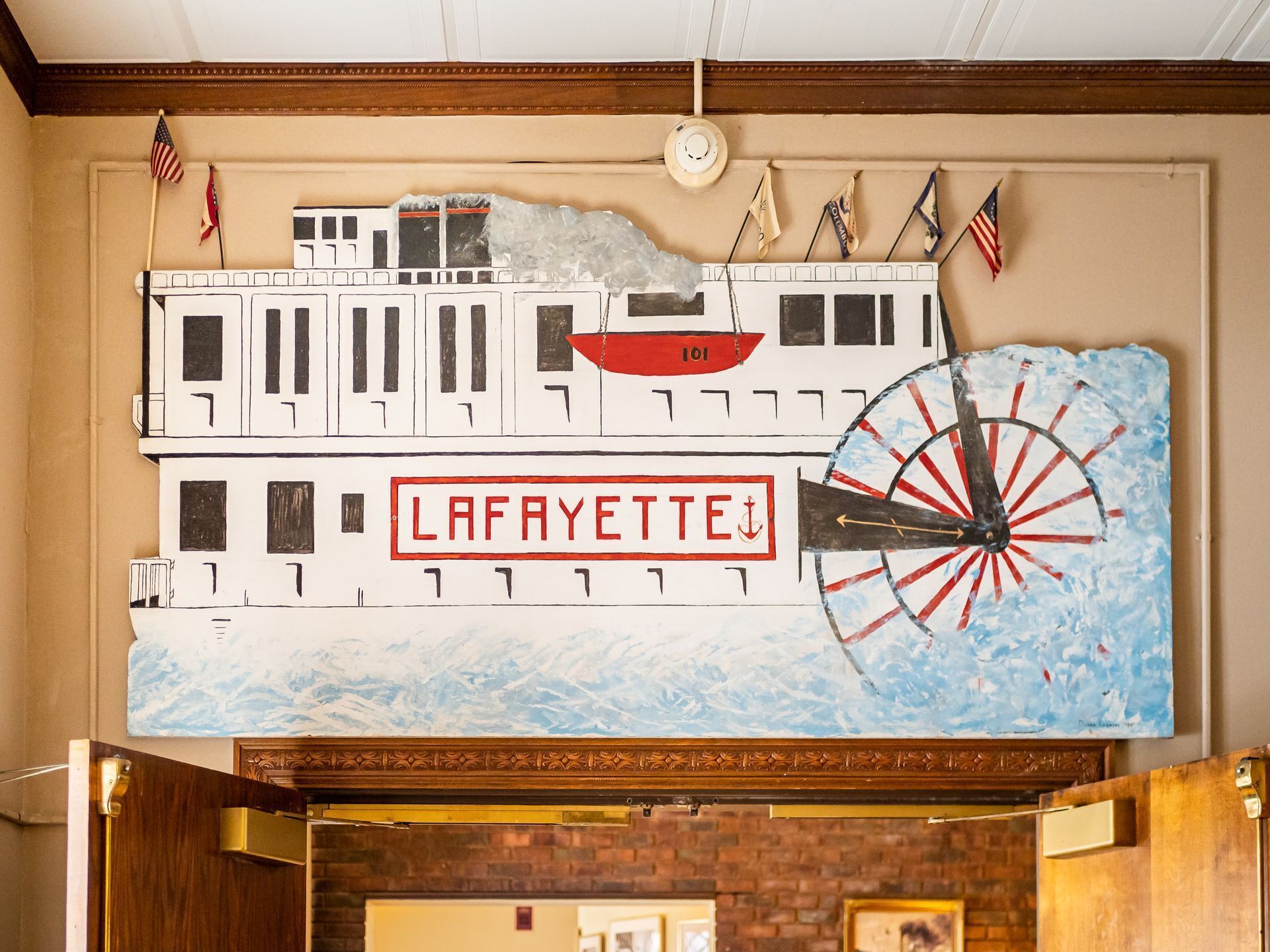 A mural of a steamboat with the name "Lafayette" on a wall.